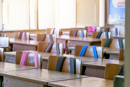 Classroom atmosphere is empty, no students in it. Student chair with student bag hanging, The concept of learning for self-improvement.の写真素材