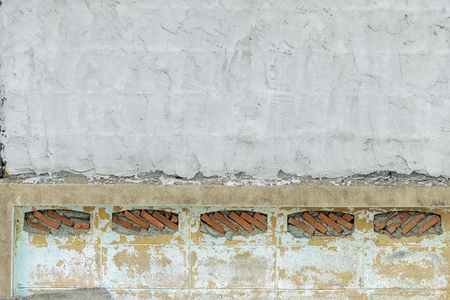 The stone wall is stacked.The stones are arranged in a rectangular, hexagonal, yellow, blue, black, whiteの写真素材