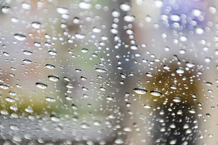 Background the glass of water is at the glass. The granularity is caused by falling rain. Make the media lonely, desolate.の写真素材