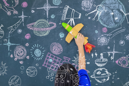 The concept of learning for self-improvement. Children who are interested in space rockets. Children who are interested in space, using paper rockets in space. Black paper with science stories.の写真素材