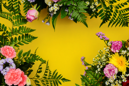 Floral picture frame concept. Placed on a yellow background to enter text, copy space.の写真素材