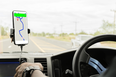 Close-up mobile smart phone inside a car, GPS navigation searching destination direction or address on gps map