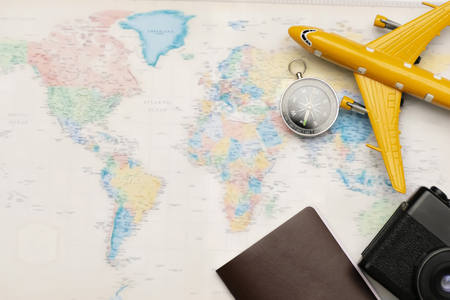 Concept travel tourism, Airplane models, Passport Thailand, camera and compass placed on the world plate. Space to enter text. Traveling to find yourself and a new experience.の写真素材