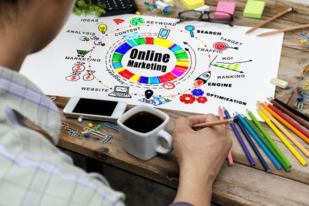 Online Marketing Digital Networking Strategy Vision Concept. Men holding pencils to write. The desk is full of stationery. Use the ideas in the design. Graphic to get effective information.の写真素材