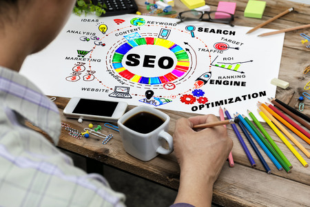 SEO concept. Men holding pencils to write. The desk is full of stationery. Use the ideas in the design. by Search Engine Optimization Graphic to get effective information.の写真素材