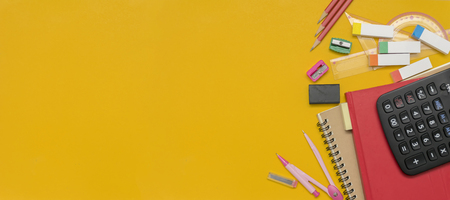 Advertising concept. Panoramas for use as media have free space to enter text. Stationery and notebooks are placed on a yellow back. Pencil, compass, eraser, ruler, calculator.の写真素材