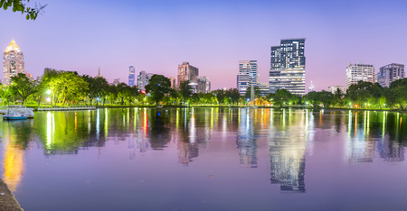 Lumpini Park in Bangkok at night Panorama concept. Thailand. Landscape view of lakeside at Lumpini Park, where people craving fresh air and physical exercise activity.の写真素材