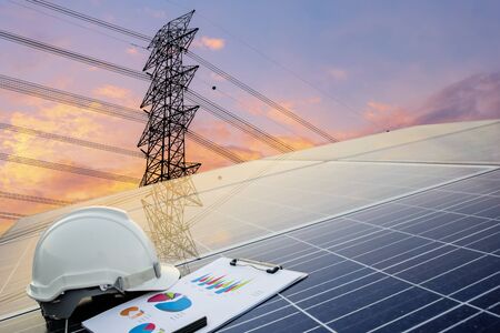 Green energy concept, Electricity station, Close up high voltage power lines at sunset. renewable energy concept with photovoltaic panels, Engineers calculate the cost.の写真素材
