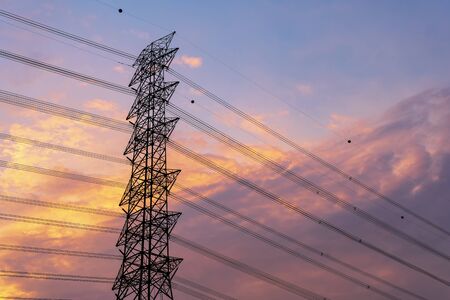 Green energy concept, Electricity station, Close up high voltage power lines at sunset. electricity distribution station. high voltage electric transmission pylon silhouetted tower.の写真素材