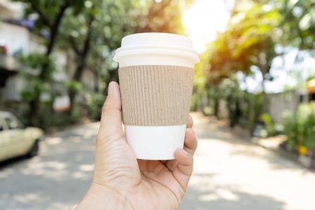 Hands holding a coffee cup that can be recycled, Coffee is one of the most popular drinks. Free space can put picture text to create an advertising media.の写真素材