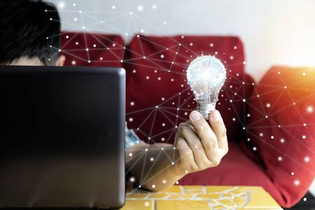 The innovation concept is due to continuous technology development.In response to commercial, Businessmen are using laptops in their hands.Is a combination of ideas from many parts to achieve success.の写真素材
