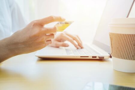 Buy online concepts Women use laptops to buy online. With credit card payments for convenience and speed, She is holding a credit card.の写真素材