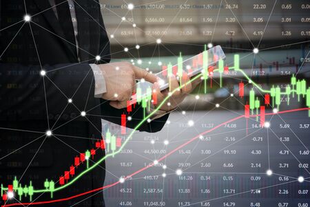 The concept of financial investment in the stock market. Businessmen are using tablets for buying...