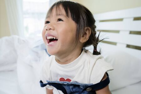 Asian girls are smiling and laughing very happily. She looked very cheerful after she had slept...