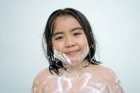 Children are bathing to cleanse the body, a white bubble next to her body, pretty face Asian boy...
