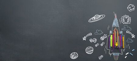 Back to School concept. School supplies, pencils, Magic Color, pens, arranged to resemble the high-speed jets, compared to learning must be encouraged as well. Background blackboard.の写真素材