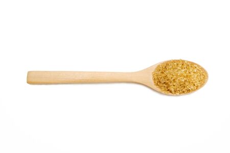 Brown sugar placed in a wooden spoon, food concept.  backdrop isolated on white background.の写真素材