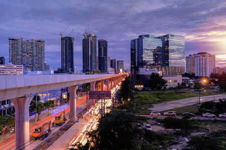 Electric train construction in Bangkok. The traffic of cars until it creates beautiful light lines.の写真素材