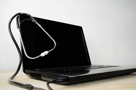 Check for care concept. Located on a computer desk, Stethoscope hanging by a doctor are connected to the headphone jack, USB.の写真素材