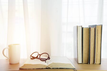 Books placed on the table by the window. Learning to develop more intelligent concept,  Morning atmosphere, clear weather.の写真素材