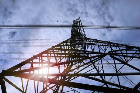 Abstract pattern from bottom view of high voltage pole power transmission tower with clear sky sunny day background  Green energy, environmental conservation concept.の写真素材