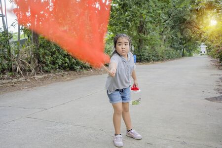 Cute Asian Girls are learning from her adventure with nature, set out to catch insects with sticks containing insect net and cans. Education, Self-learning experience. She is committed concept.の写真素材