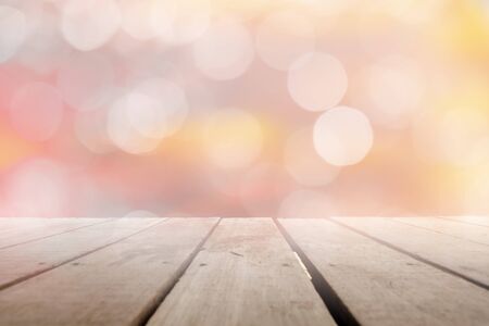 Empty of wood table top with blurred light gold, Pink bokeh abstract background. For montage product display or design key visual layout.の写真素材
