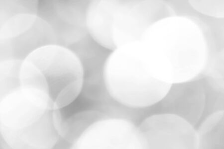 Grey bokeh with white color abstract background can be use as wallpaper, Christmas card background or new year card background. The background show light bokeh which on defocused light.の写真素材