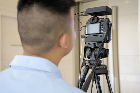 Amateur photographer, he is learning to develop as a professional photographer. A successful professional photographers. The camera can also shoot video, mounted on a tripod.の写真素材