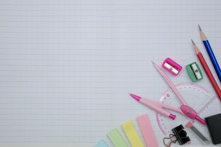 Mathematics concept, Writing utensils. A thumbscrew compass for setting and maintaining a precise radius, Ruler, eraser, placed on a graph book.の写真素材