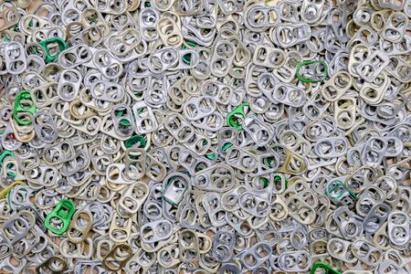 Collection of metal ring pull for can opener background concept. Overlapping a large number of colorful reliefs.の写真素材