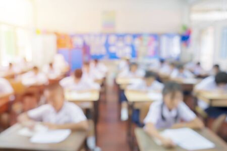 Back to school, education concept. Classroom in blur background young student; Blurry view of elementary class room kid or teacher with chairs and tables in campus.の写真素材