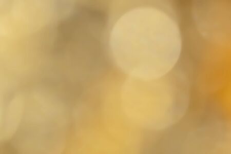 Gold abstract bokeh background. Abstract Golden glare on abstract bokeh background.の写真素材
