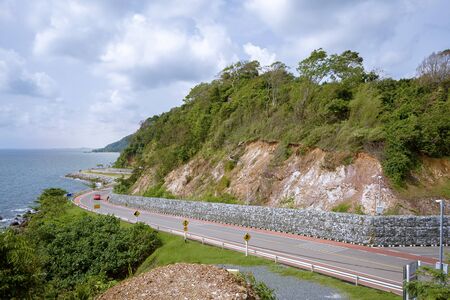 Khung Wiman Beach, Chanthaburi Province Hills and beautiful sea views which are beautiful scenic spots in the eastern part of Thailand. The red car is driving.の写真素材