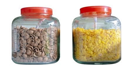 There are 2 dozen glass jars containing cornflakes. There are yellow and brown types, this is a very popular breakfast.の写真素材