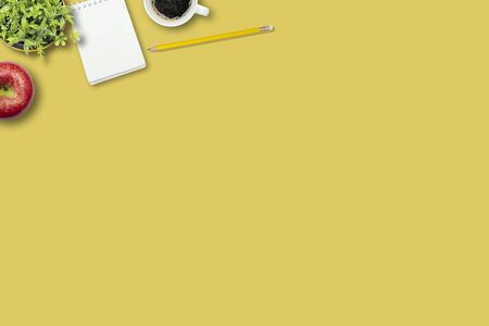 Educational ideas concept, red apples, coffee cups, notebooks and pencils, placed on yellow isolated...