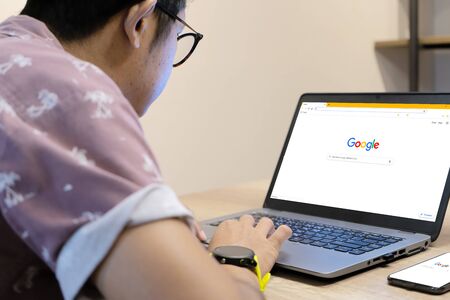February 8, 2019 Bangkok, Thailand : Asian Men is typing on Google search engine from a laptop....