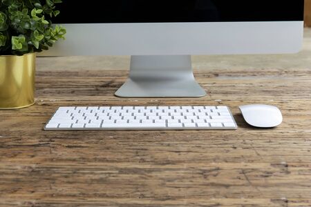 Computer, keyboard, mouse placed on the desk, there is space in front to put textの写真素材