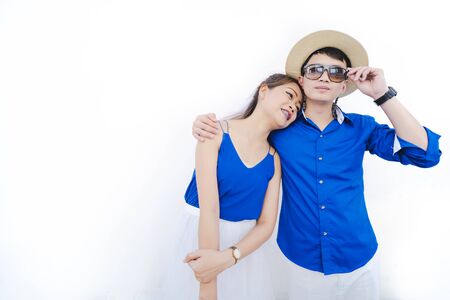 Happy young Asian couple in love having a good time. Happy beautiful young Asian woman embracing her boyfriendの写真素材