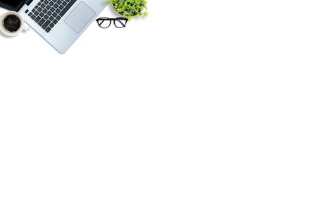 Top view of the desk concept. white desk is equipped with work equipment, laptops, coffee cups, glasses.の写真素材