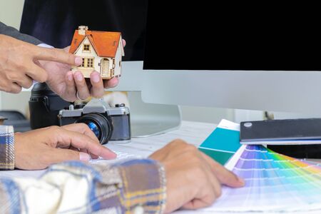 Architects or engineers and the interior decorator of the Asian decorator choose material samples in the studio. Color swatch, house models, computers to help designの写真素材