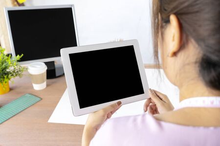 Asian female designers are on the tablet looking for new information concept, ideas, modern fashion, to create their work. Blank tablet screenの写真素材