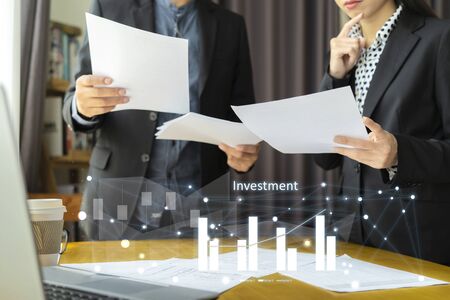 Business teamwork concept. Currently consulting about investment problems for business expansion. Hold the document in the hand, Graphic bar graph foregroundの写真素材