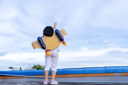 Kid with jet pack pretend to be superhero. Child playing in summer outdoors. Success, leader and winner conceptの写真素材