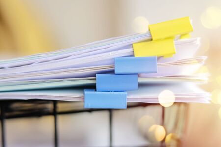 Documents placed in the office on the document basket by using clips to classify important content....