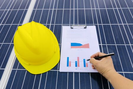 Engineer working on checking and maintenance equipment at industry solar power, Chart Section Power consumption. Working solar station photovoltaic panels, Scienceの写真素材