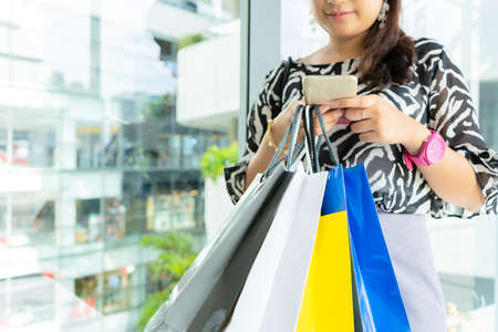 Asian business woman using mobile smart phone outdoor, Online shopping, woman happy.の写真素材