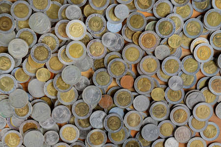 Background coins (Thai money) on table, Silver and gold Thai baht coinsの写真素材