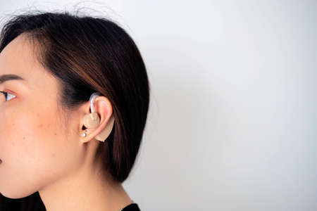 Hearing aid concept. Modern digital in the ear hearing aid for deafness and the hard of hearing patients.の写真素材