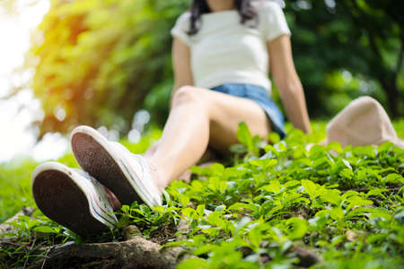 Asian woman resting Relaxing in the park concept, soft sunlight, light atmosphere.の写真素材